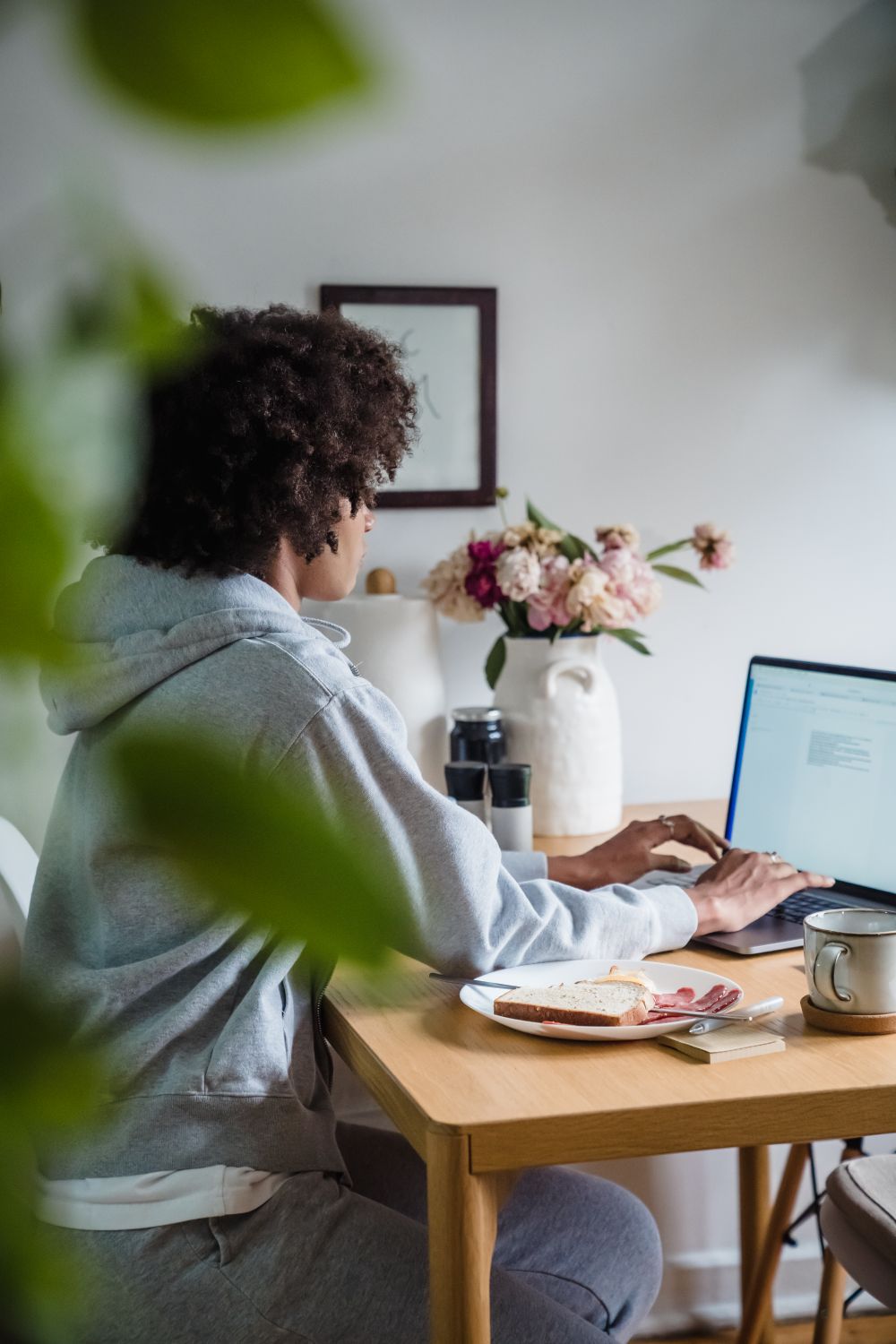A member working at a laptop at home