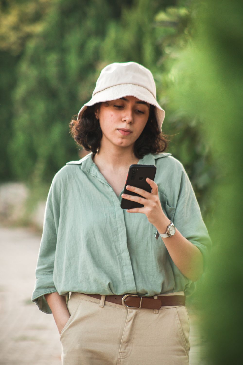A person signing up on a phone outdoors