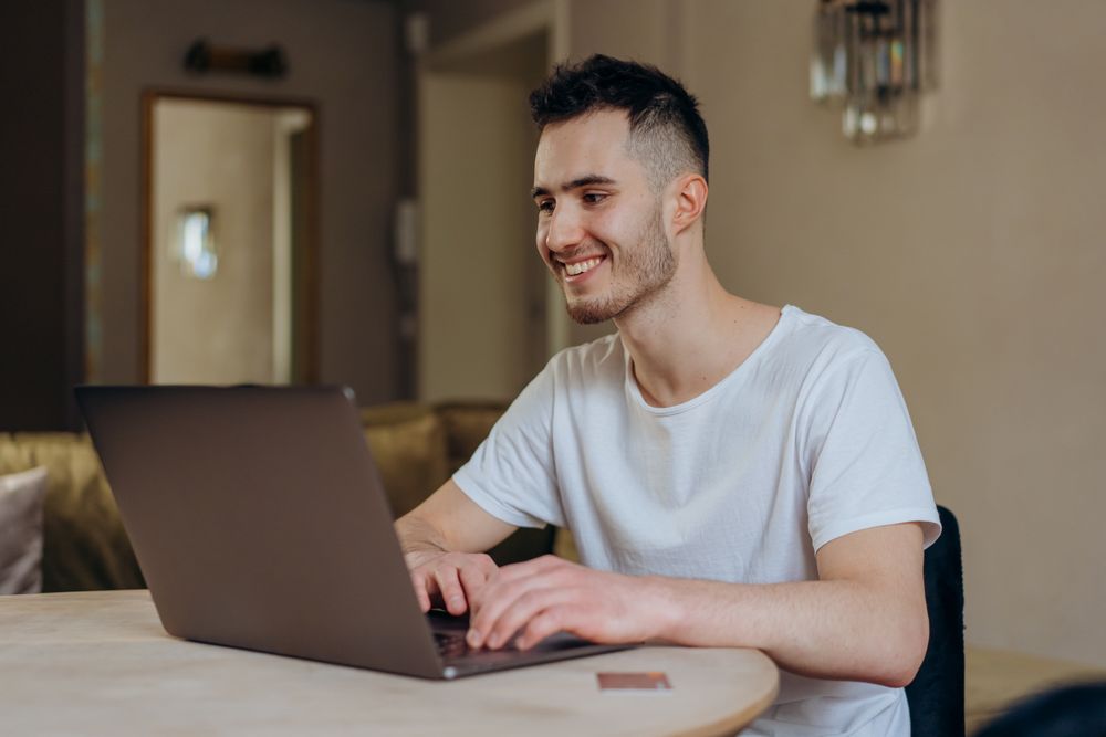 A visitor filling in a form on a laptop